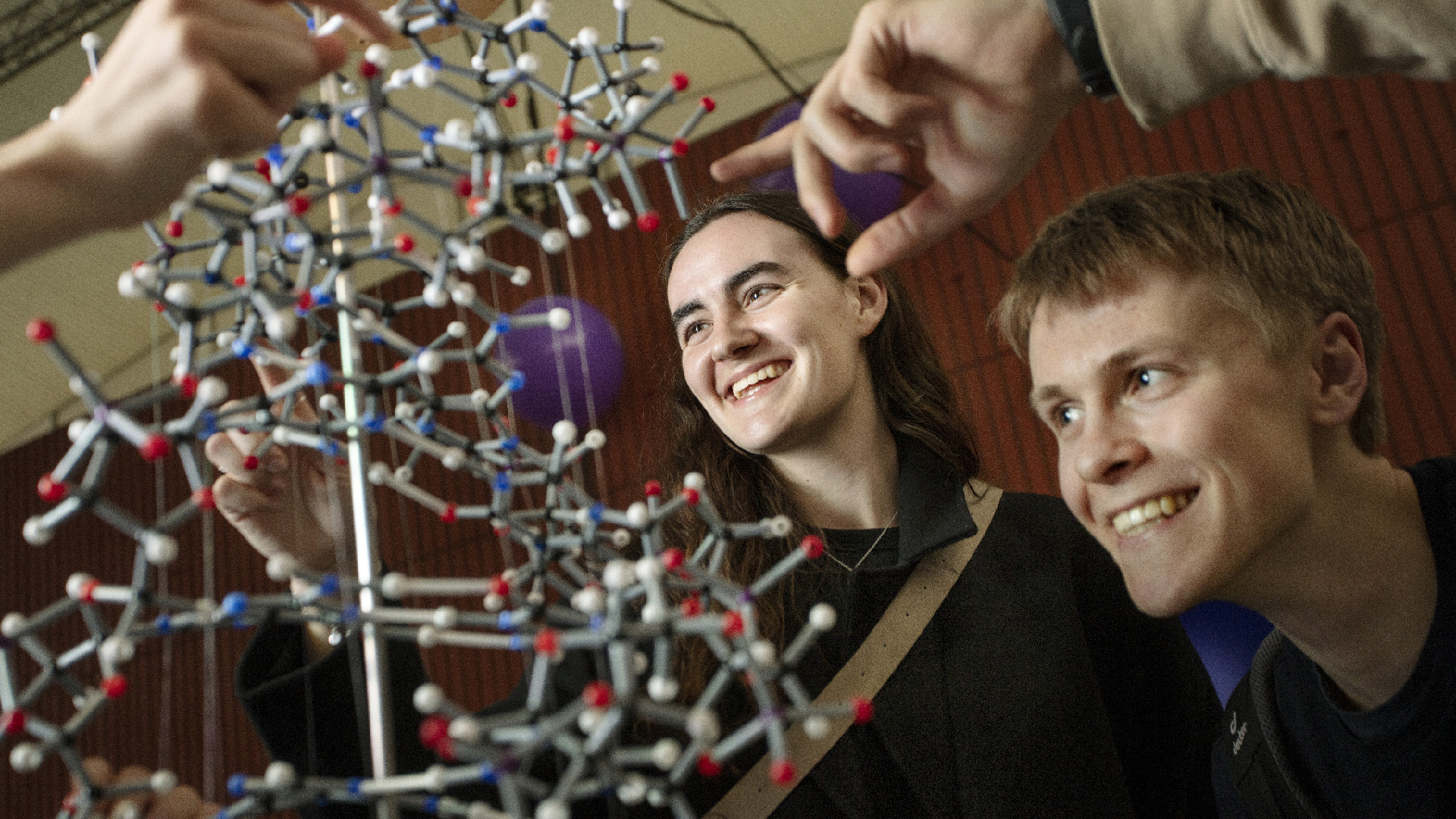Young students looking at model