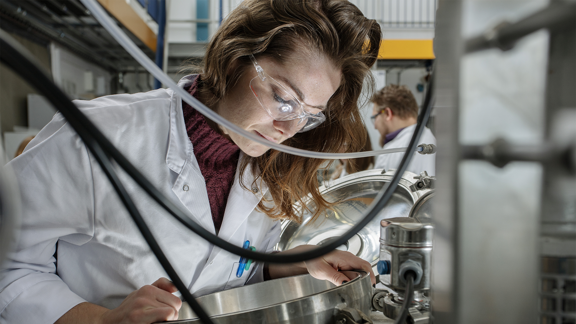 Student looking into fermentor